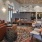 Spacious and well lit living room with wood flooring, large windows and open access to the kitchen