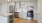 Camas, WA Apartments - Ninebark - Kitchen with Stainless Steel Appliances Including a Built-in Dishwasher, Built-in Microwave, and Refrigerator, Along with White Quartz Countertops, White Tile Backsplash, Wood-Style Vinyl Plank Flooring, and Large Island