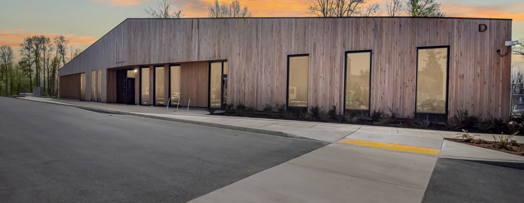 Exterior view of the lobby and leasing office at sunset