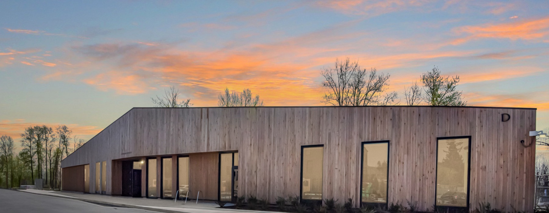 Exterior view of the lobby and leasing office at sunset