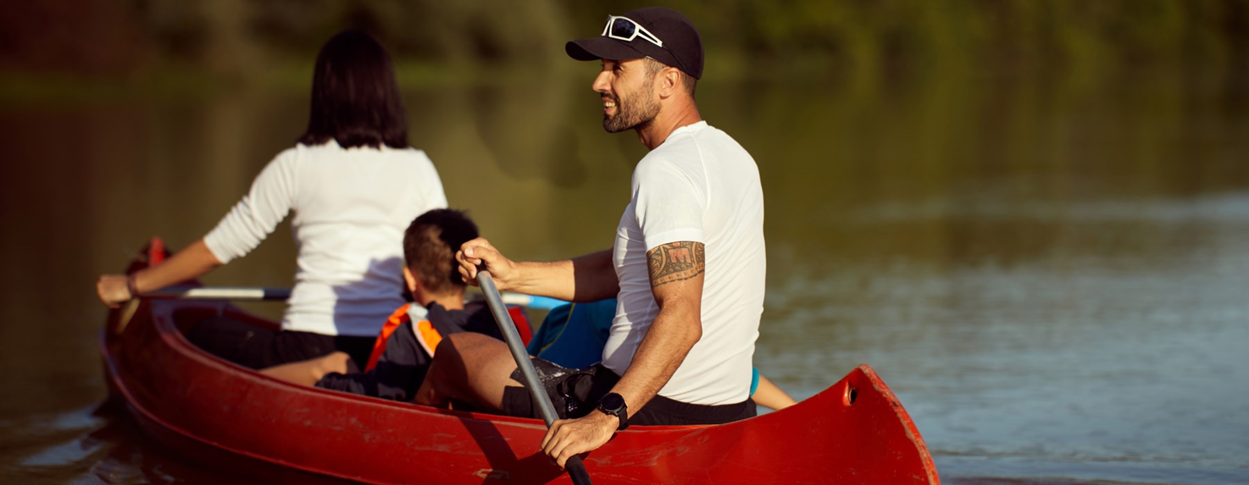 Family enjoying a day canoeing in the lake 