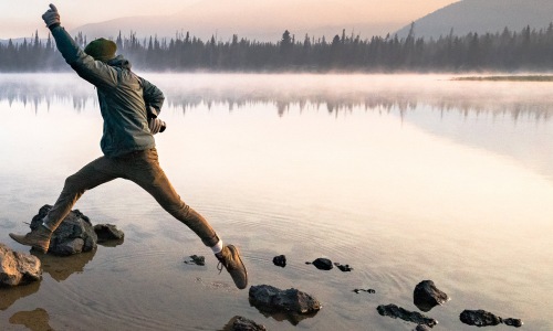 Man running on stones near the lake 